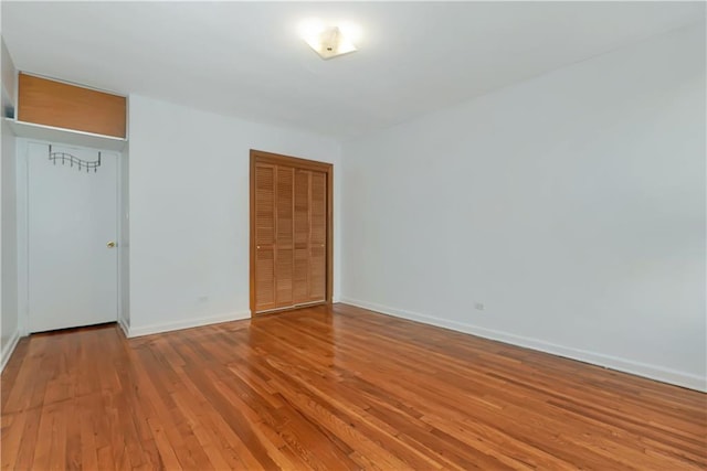 unfurnished room with light wood-style floors and baseboards