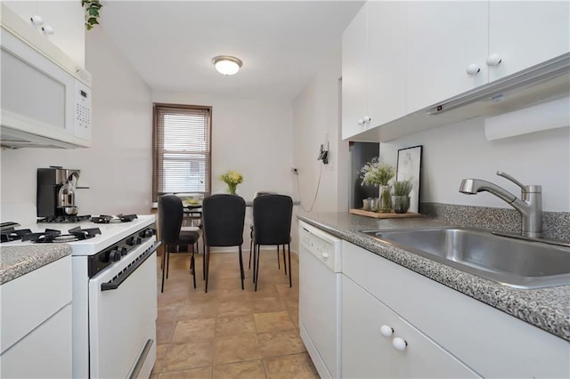 kitchen featuring white appliances, sink, and white cabinets