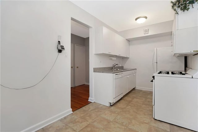 kitchen with sink, white appliances, and white cabinets