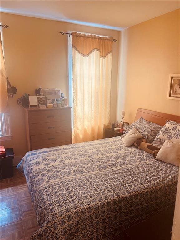 bedroom featuring dark parquet floors