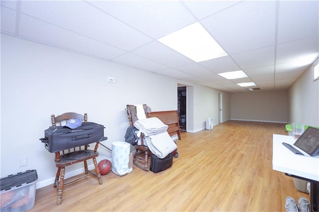 interior space with hardwood / wood-style floors and a drop ceiling