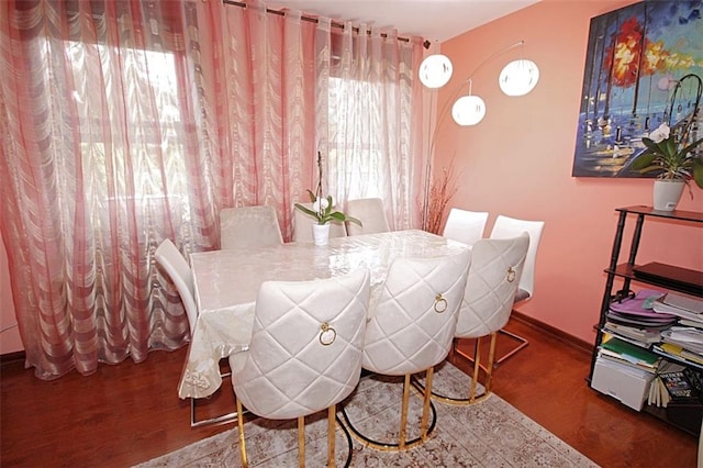 dining area featuring wood finished floors and baseboards