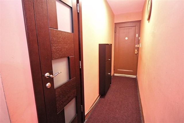 corridor featuring dark carpet