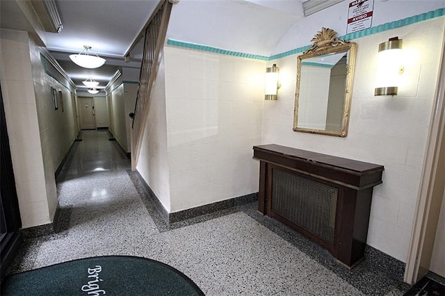 corridor featuring speckle patterned floor