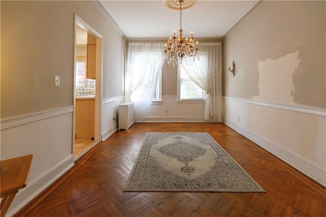 unfurnished dining area with baseboards, radiator, and a chandelier