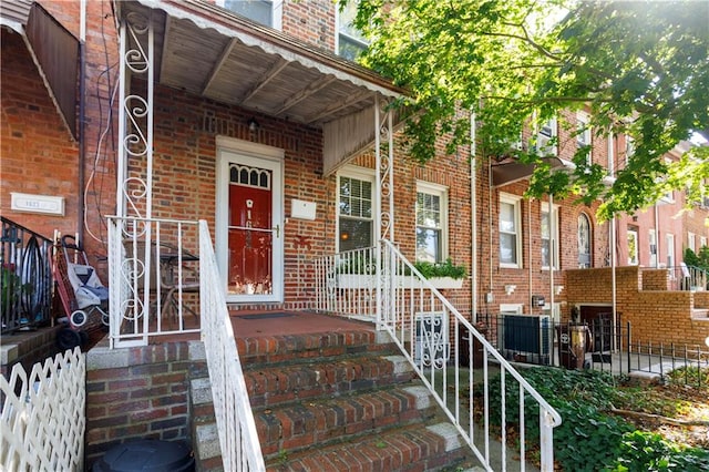 entrance to property featuring brick siding