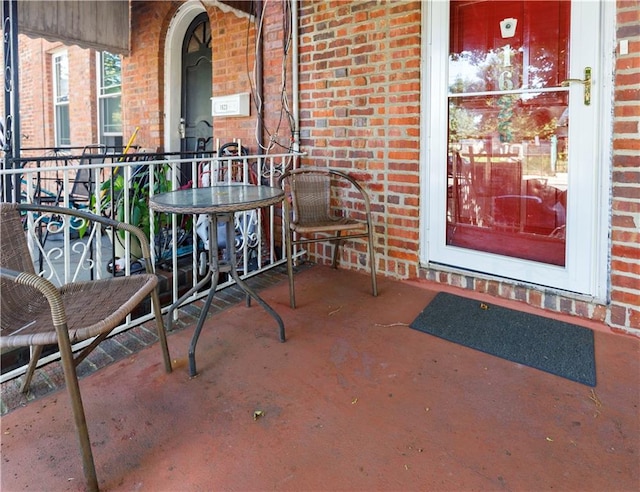 property entrance featuring brick siding