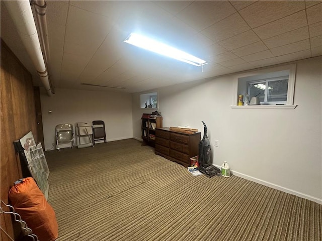 basement featuring dark colored carpet