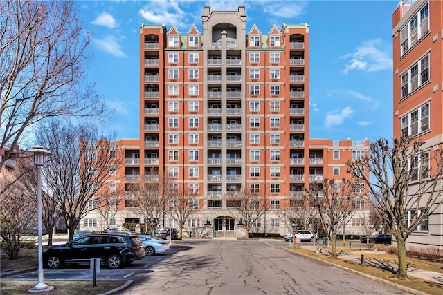 view of building exterior with uncovered parking