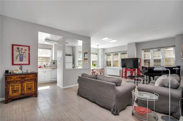 living area featuring a wealth of natural light and baseboards