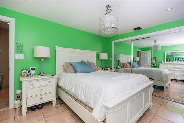 tiled bedroom featuring a closet