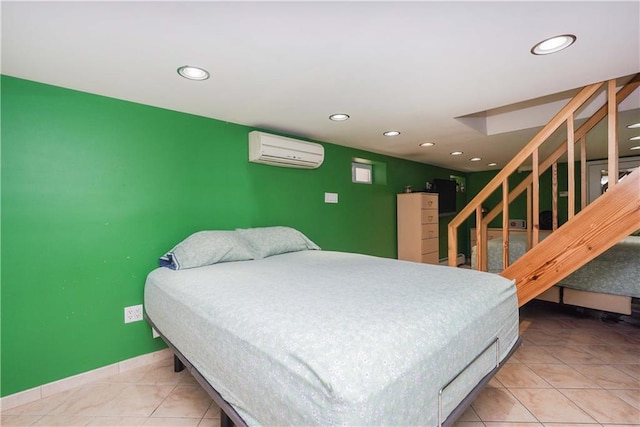 bedroom featuring tile patterned floors and an AC wall unit