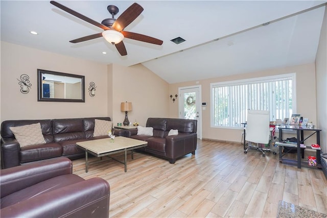 living room with ceiling fan, lofted ceiling, and light hardwood / wood-style flooring