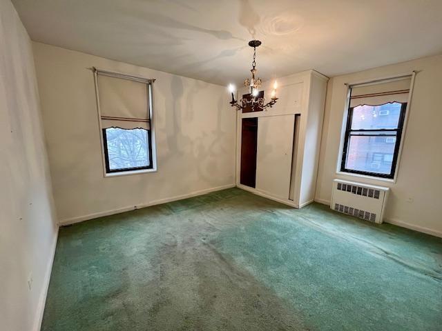 2270 Plumb 1st St Unit 4F, Brooklyn, NY 11229 - unfurnished dining area featuring carpet flooring, a notable chandelier, radiator heating unit, and baseboards