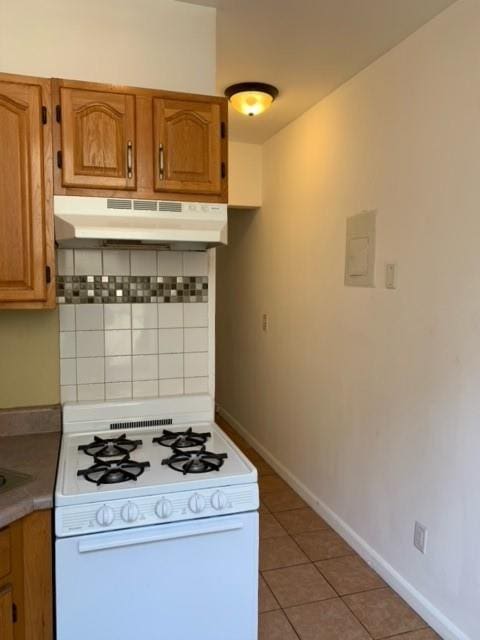 kitchen featuring electric panel, tasteful backsplash, white range, wall chimney range hood, and light tile patterned floors