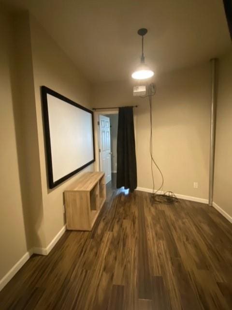 cinema room with dark wood-type flooring