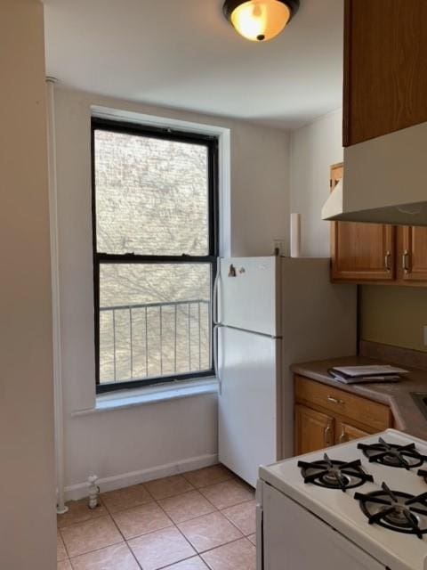 kitchen with light tile patterned floors and stove