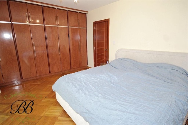 bedroom with light parquet flooring