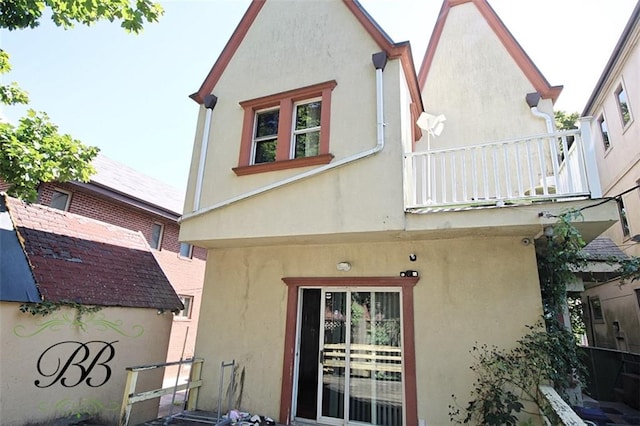 rear view of property featuring a balcony