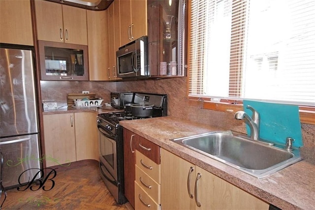 kitchen featuring stainless steel appliances, tasteful backsplash, sink, and dark parquet flooring