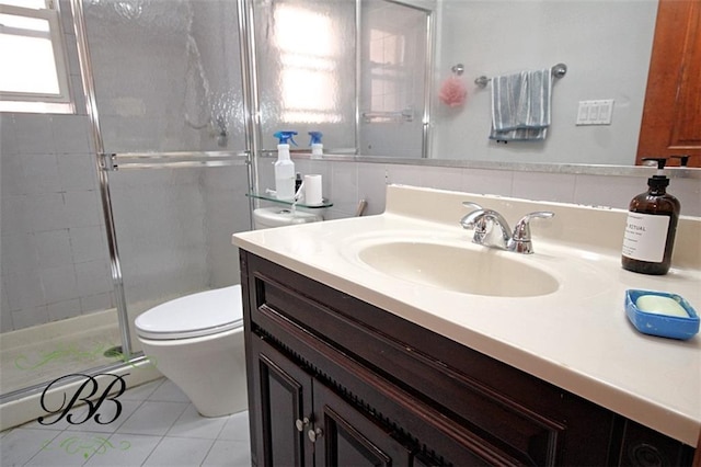 bathroom featuring toilet, vanity, tile patterned floors, and walk in shower