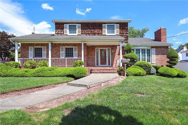 view of front of house featuring a front yard, a porch, and cooling unit