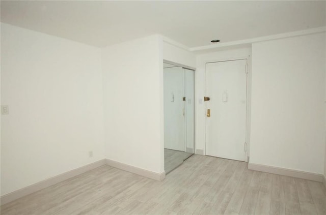 unfurnished room with light hardwood / wood-style flooring