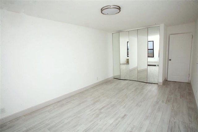 empty room with light hardwood / wood-style flooring