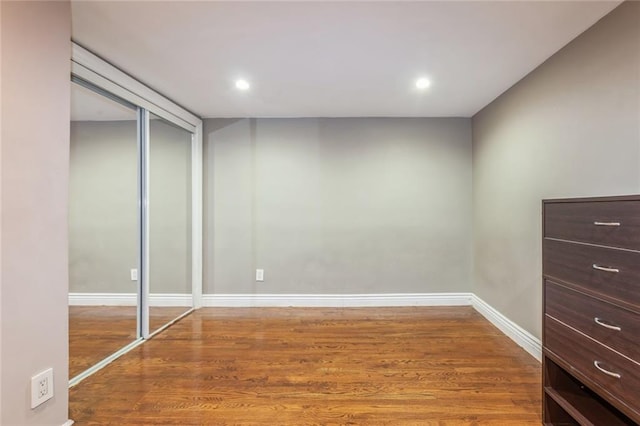 interior space with wood-type flooring and a closet