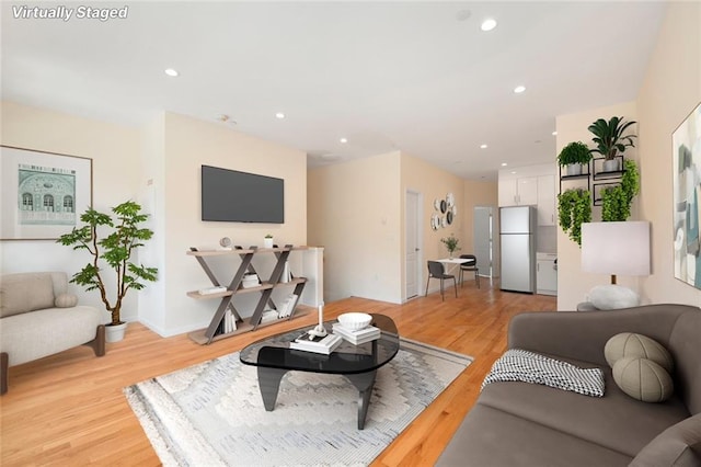 living area featuring recessed lighting and light wood-type flooring