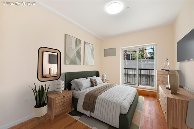 bedroom featuring light wood-type flooring and baseboards