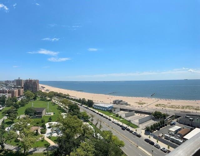 birds eye view of property featuring a view of the beach and a water view