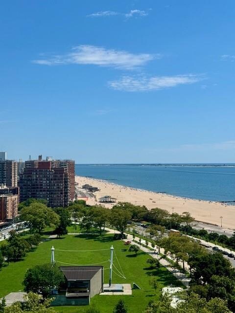 surrounding community featuring a water view and a view of the beach