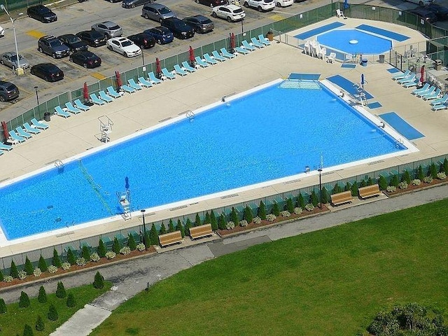 view of swimming pool featuring fence