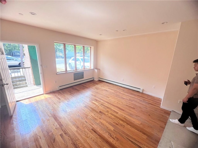 1171 86th St Unit 1B, Brooklyn, NY 11228 - spare room featuring a baseboard heating unit, plenty of natural light, light wood-style flooring, and recessed lighting