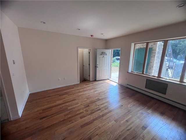 1171 86th St Unit 1B, Brooklyn, NY 11228 - empty room featuring baseboard heating and wood finished floors