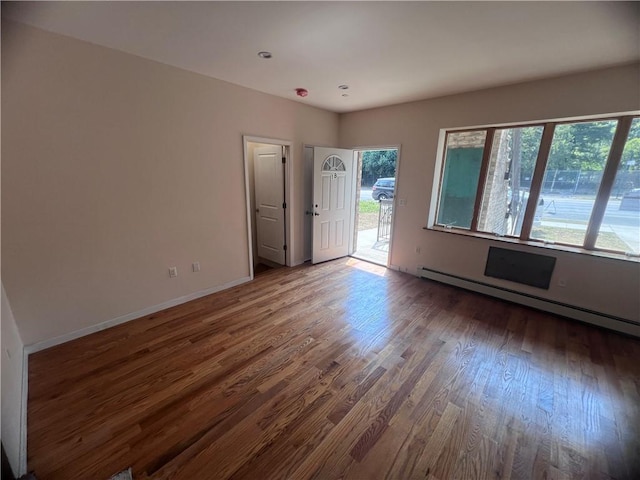 1171 86th St Unit 1B, Brooklyn, NY 11228 - unfurnished room with baseboard heating and wood finished floors