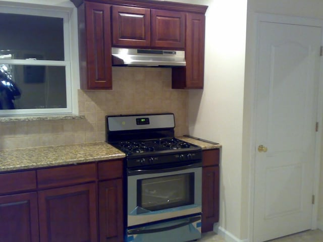 kitchen featuring decorative backsplash and stainless steel gas stove