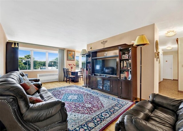 living room featuring radiator and light hardwood / wood-style floors