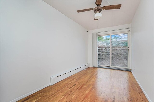 empty room with light hardwood / wood-style floors, ceiling fan, and baseboard heating