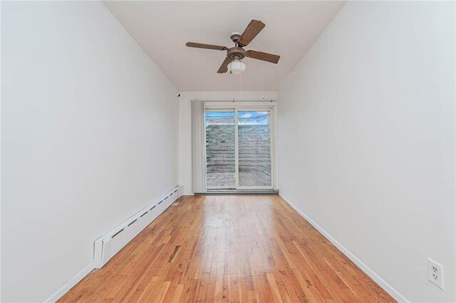 unfurnished room featuring baseboard heating, ceiling fan, and light hardwood / wood-style flooring