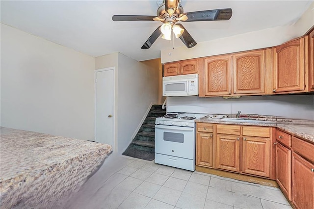 kitchen featuring sink, white appliances, ceiling fan, and light tile patterned flooring