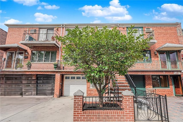 view of property with a garage and a balcony