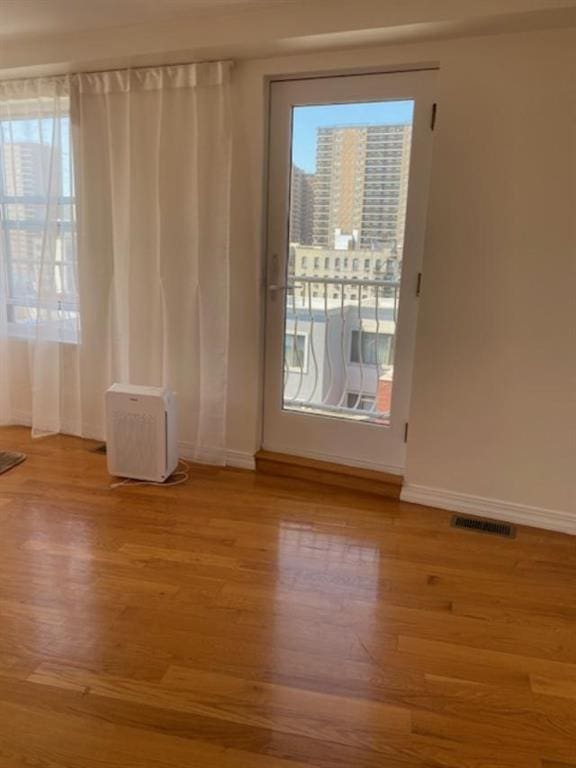 unfurnished room with light hardwood / wood-style floors