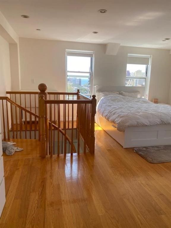 bedroom featuring multiple windows and light hardwood / wood-style flooring