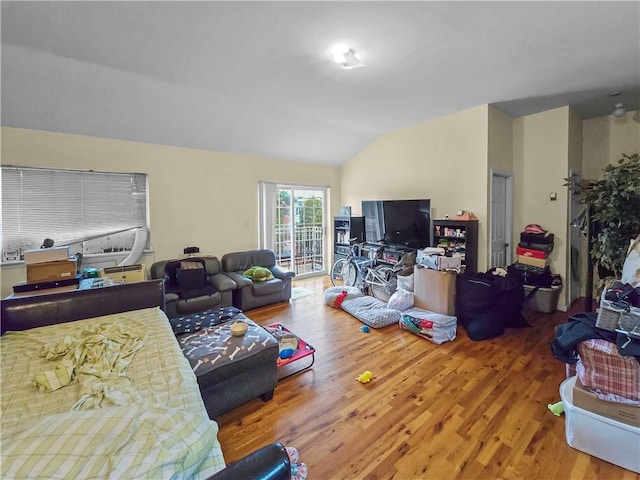 living room featuring hardwood / wood-style floors and vaulted ceiling