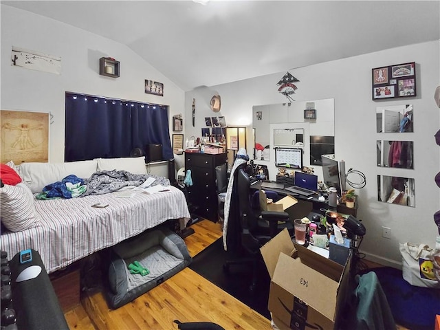 bedroom with lofted ceiling and hardwood / wood-style floors