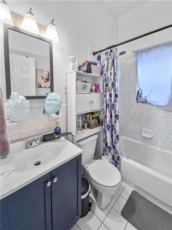 full bathroom featuring toilet, shower / tub combo with curtain, vanity, and tile patterned floors