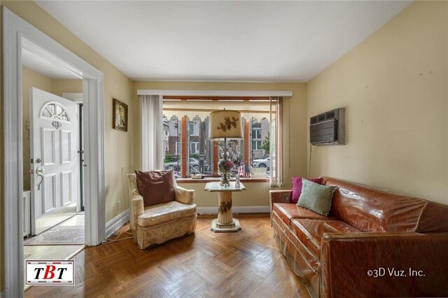 living area with a wall unit AC and parquet floors