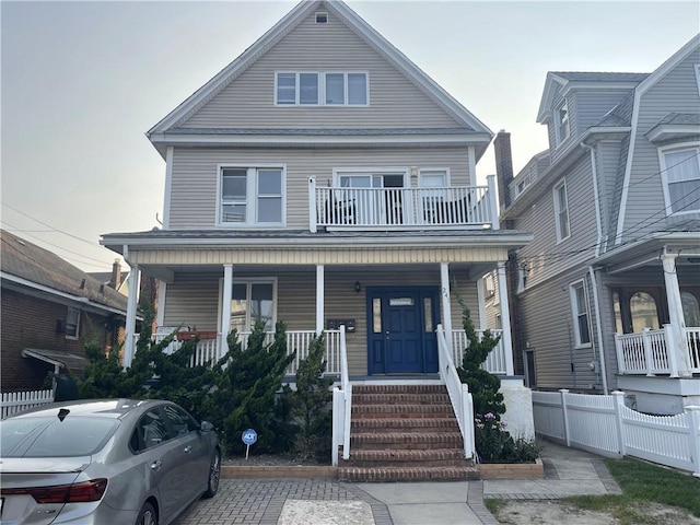 view of front of house featuring a balcony and covered porch